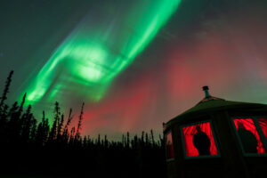 aurora over a yurt at night